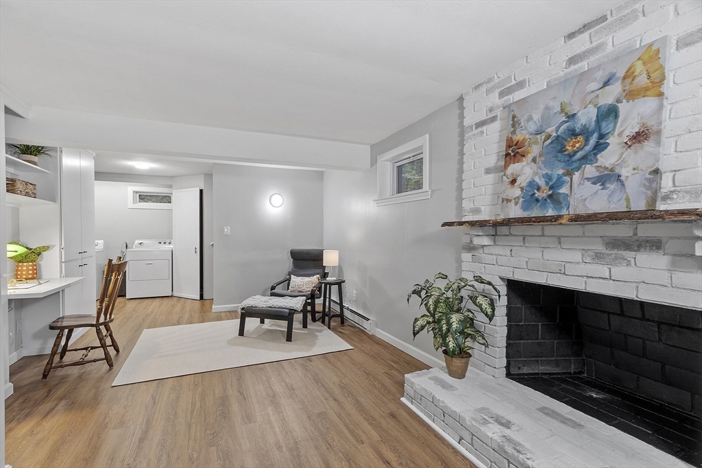167 Harvard Road Stow, MA 01775 - Photo 25 of 27 a living room with furniture a fireplace and wooden floor
