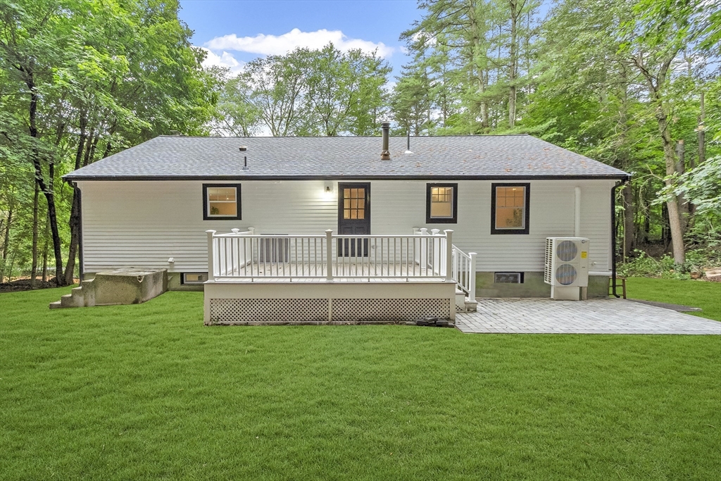 167 Harvard Road Stow, MA 01775 - Photo 4 of 27 a front view of a house with a garden and yard