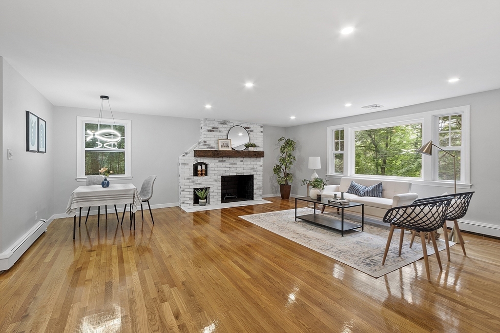 167 Harvard Road Stow, MA 01775 - Photo 5 of 27 a living room with furniture a fireplace and a table