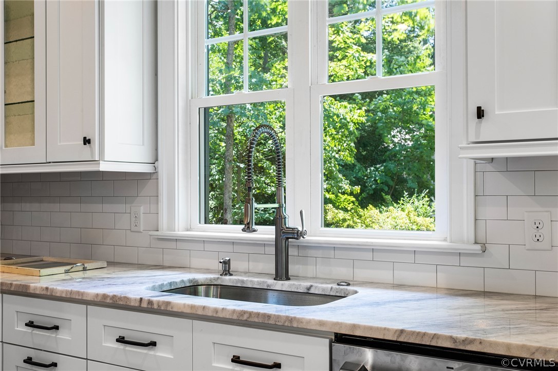 3703 Custis Road Richmond, VA 23225 - Photo 13 of 33 a kitchen with granite countertop a sink window and cabinets