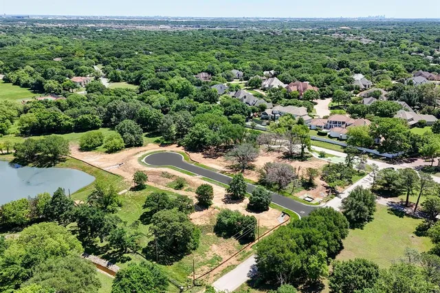 an aerial view of a houses with a yard