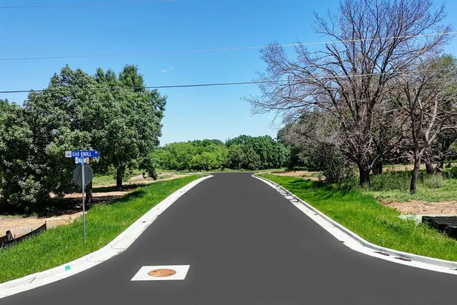 a view of a street with a park