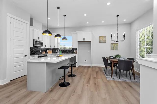 a kitchen with a sink cabinets and wooden floor