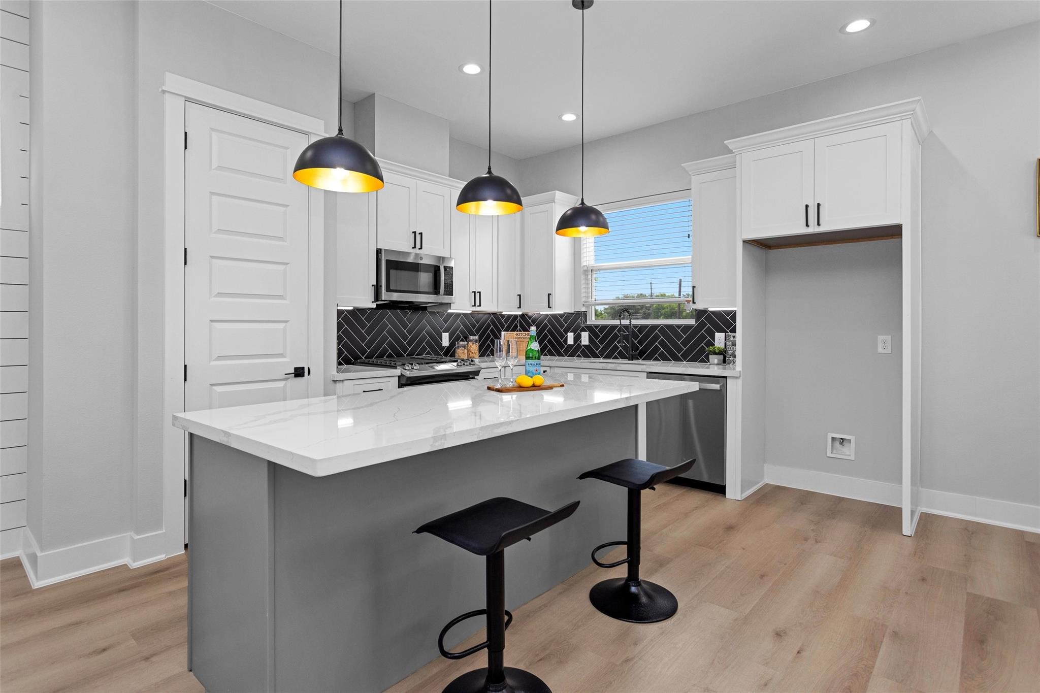 1616 Euel Street Houston, TX 77009 - Photo 13 of 42 a kitchen with a sink cabinets and wooden floor