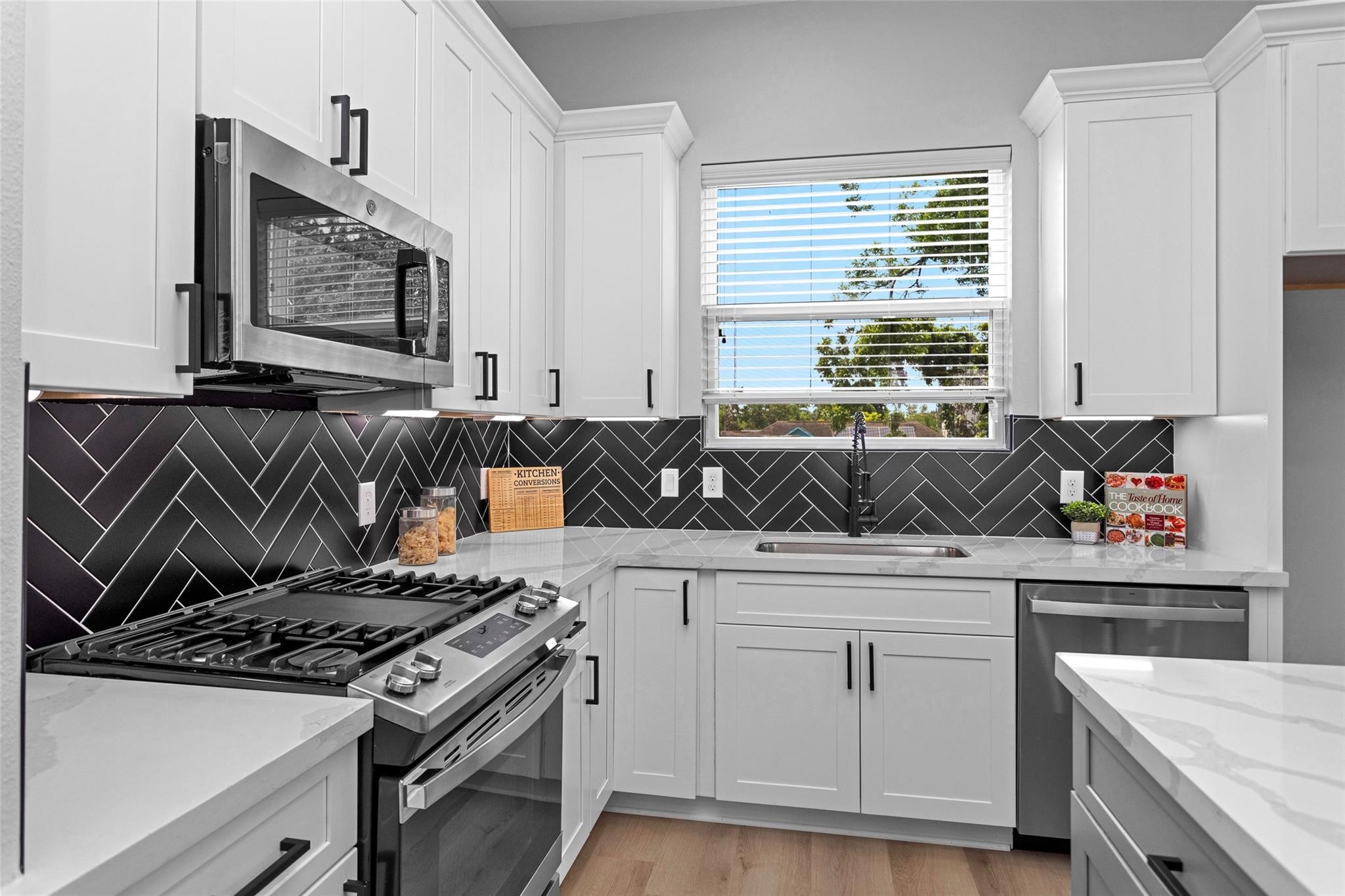 1616 Euel Street Houston, TX 77009 - Photo 16 of 42 a kitchen with white cabinets and appliances