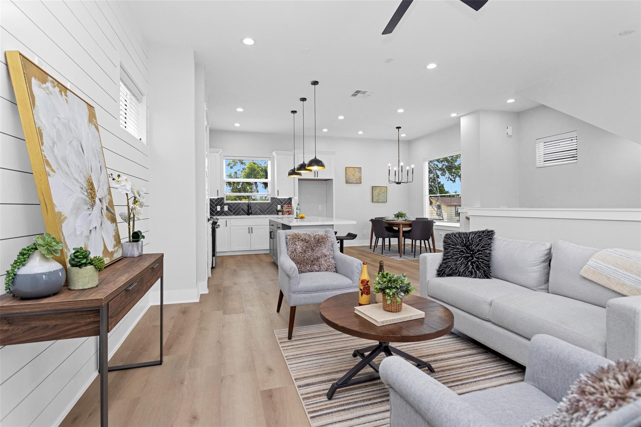 1616 Euel Street Houston, TX 77009 - Photo 20 of 42 a living room with furniture and a dining table with kitchen view