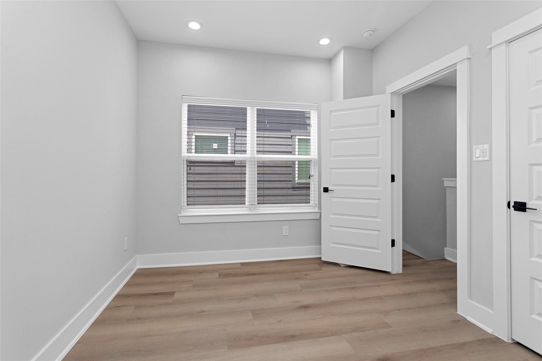 1616 Euel Street Houston, TX 77009 - Photo 29 of 42 wooden floor in an empty room with a window
