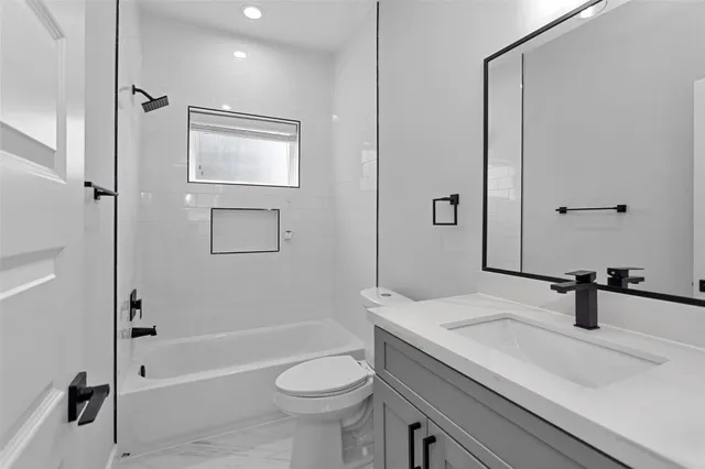 a bedroom with a bed table and a window