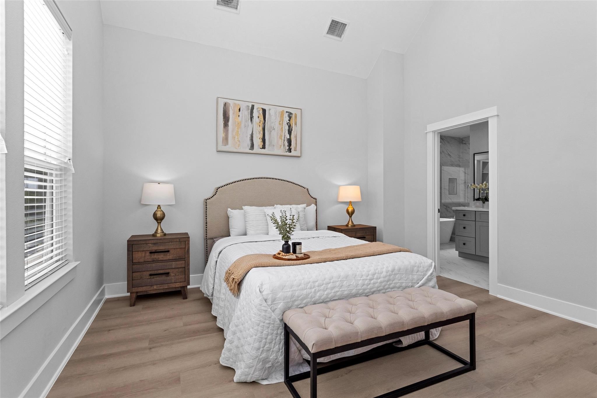 1616 Euel Street Houston, TX 77009 - Photo 33 of 42 a bedroom with a bed and a dresser with wooden floor