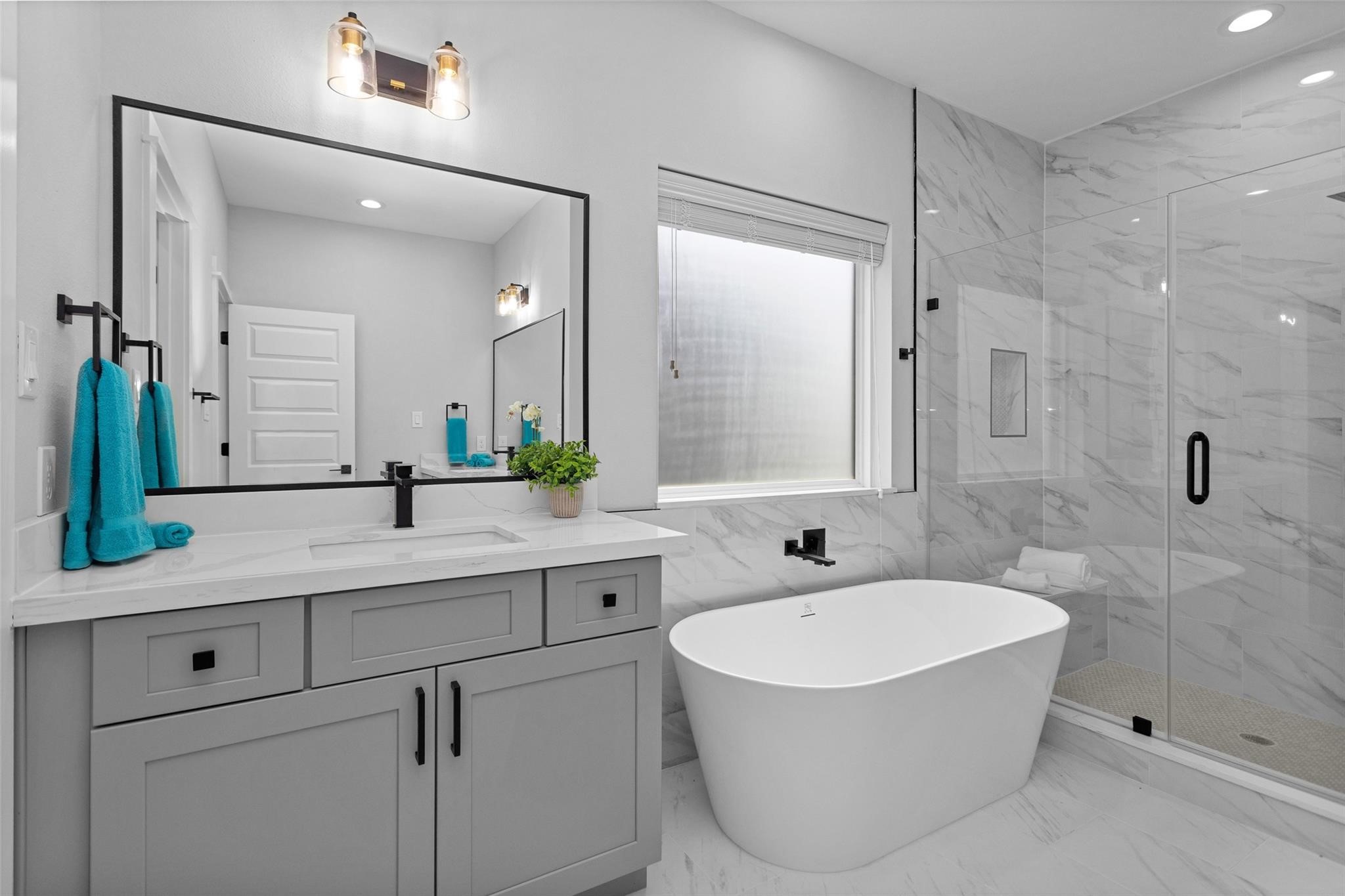 1616 Euel Street Houston, TX 77009 - Photo 36 of 42 a bathroom with a double vanity sink mirror and bathtub