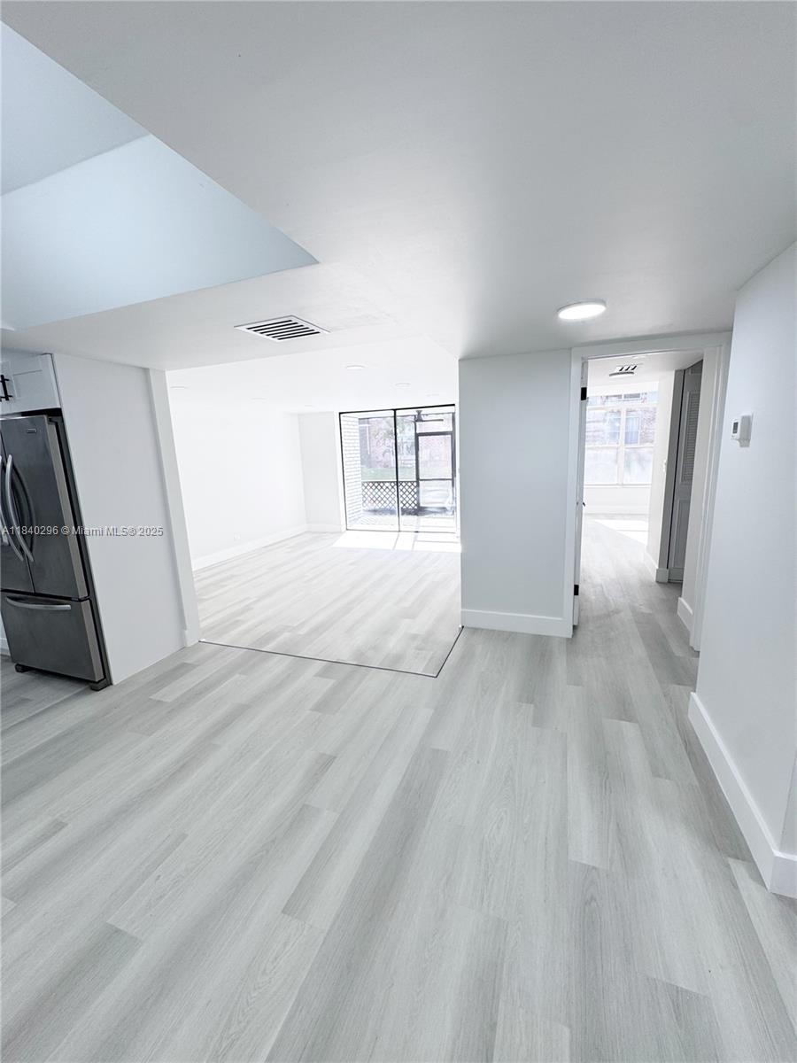3660 Inverrary Drive, Unit 1Y Lauderhill, FL 33319 - Photo 12 of 24 a view of empty room with wooden floor