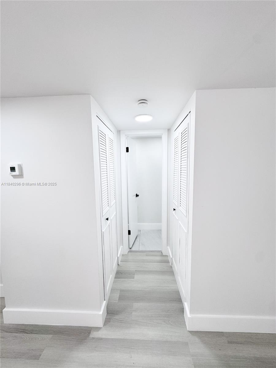 3660 Inverrary Drive, Unit 1Y Lauderhill, FL 33319 - Photo 14 of 24 a view of a hallway with wooden floor and staircase