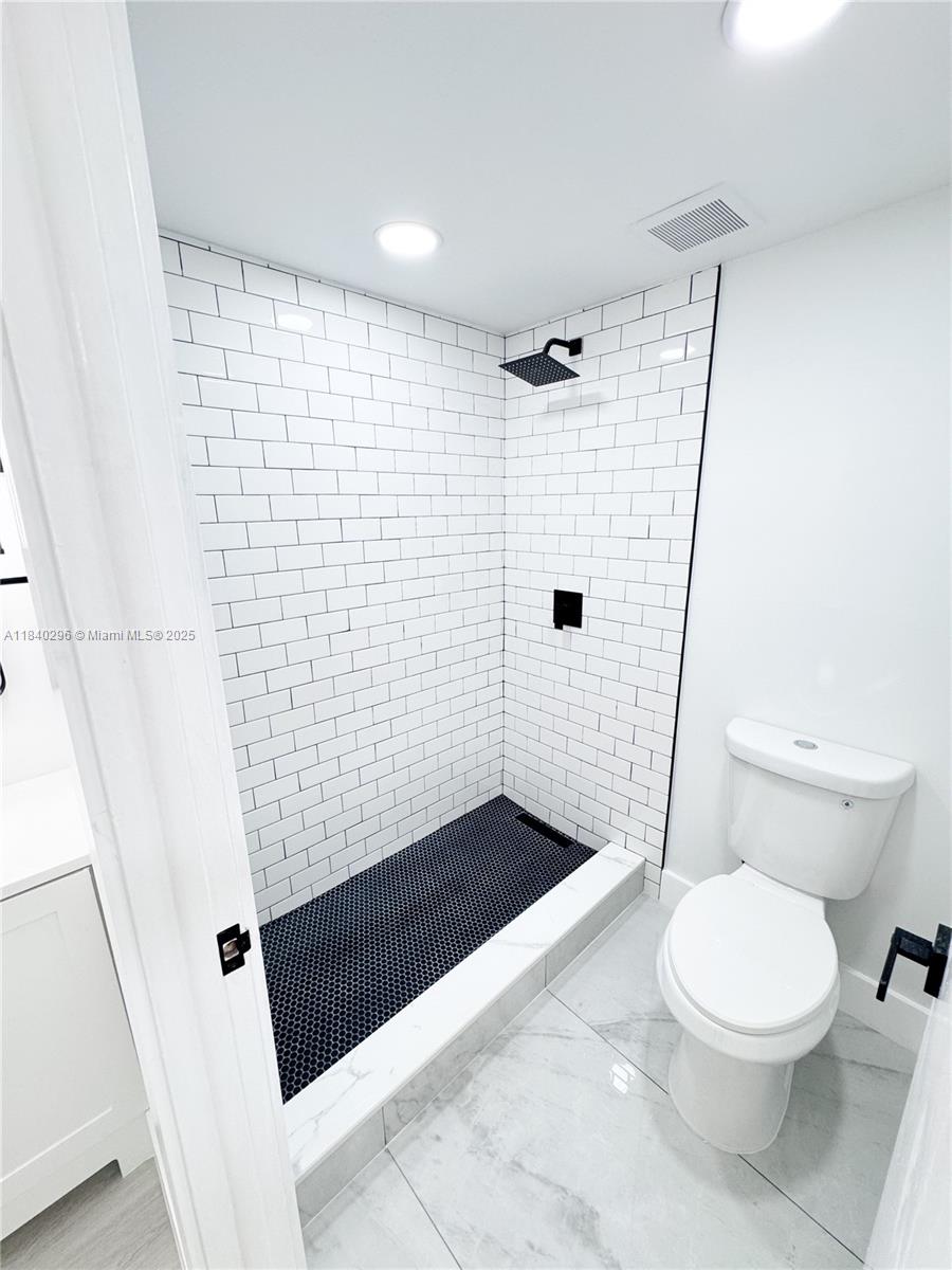 3660 Inverrary Drive, Unit 1Y Lauderhill, FL 33319 - Photo 15 of 24 a bathroom with a shower and a toilet