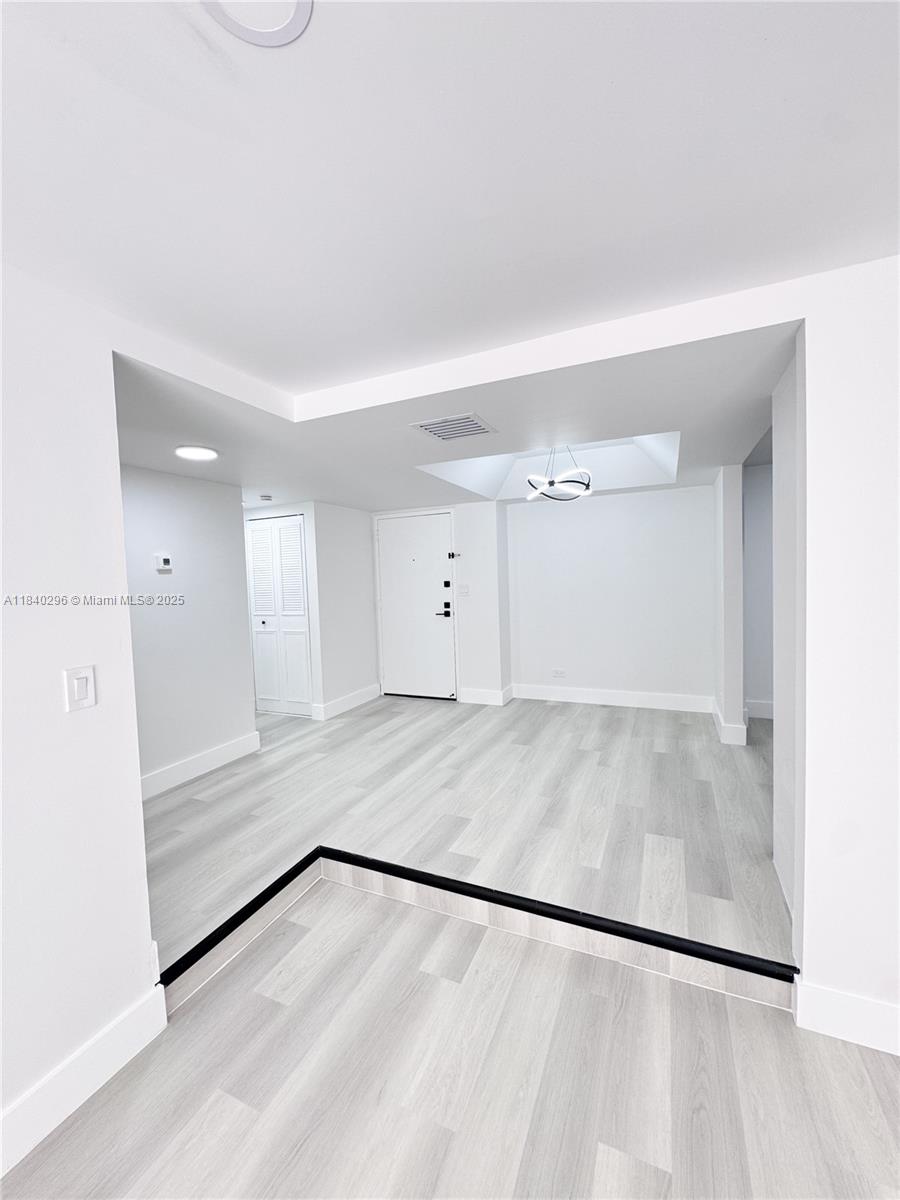 3660 Inverrary Drive, Unit 1Y Lauderhill, FL 33319 - Photo 7 of 24 a view of empty room with wooden floor