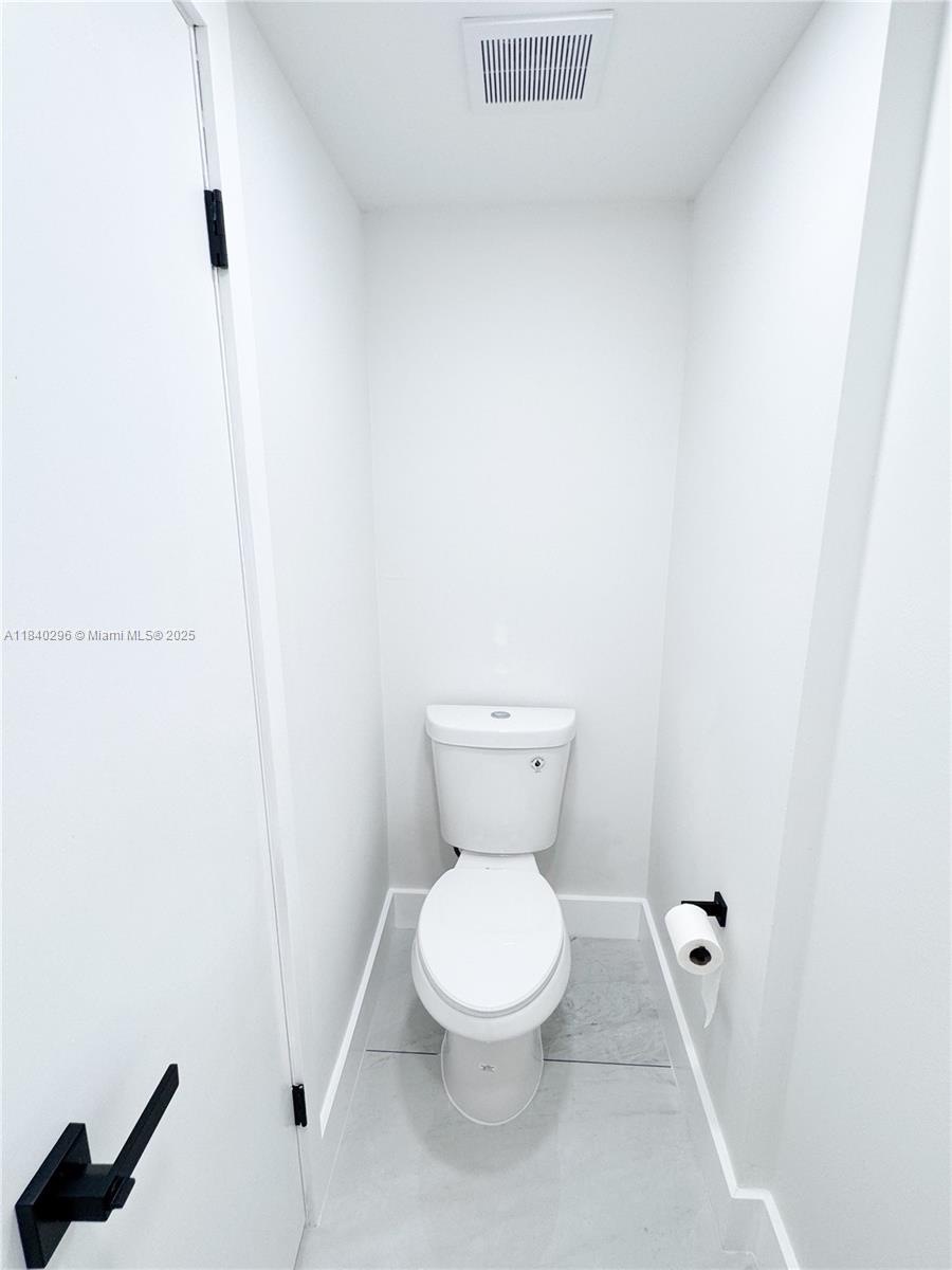 3660 Inverrary Drive, Unit 1Y Lauderhill, FL 33319 - Photo 9 of 24 a white toilet sitting next to a white sink