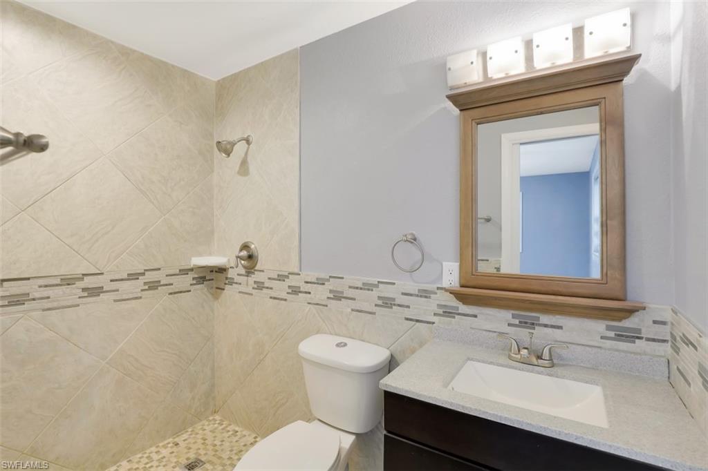 19109 Birch Road Fort Myers, FL 33967 - Photo 16 of 24 a bathroom with a sink toilet and vanity