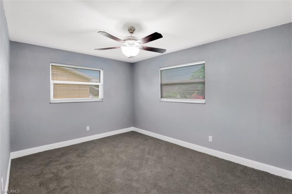 19109 Birch Road Fort Myers, FL 33967 - Photo 17 of 24 an empty room with a window and a fan
