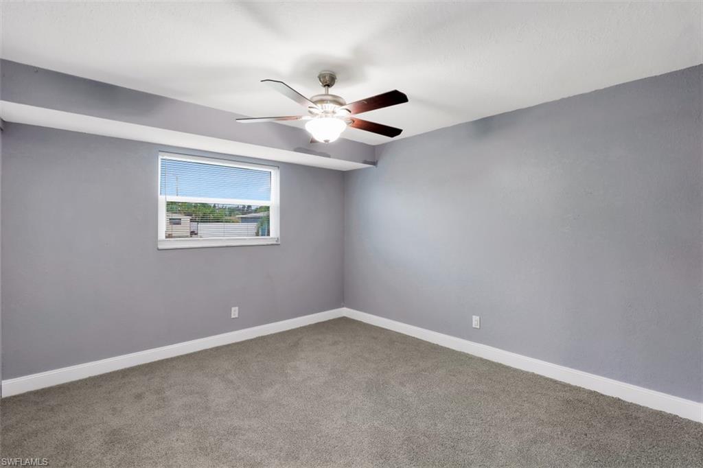 19109 Birch Road Fort Myers, FL 33967 - Photo 18 of 24 an empty room with a window and ceiling fan