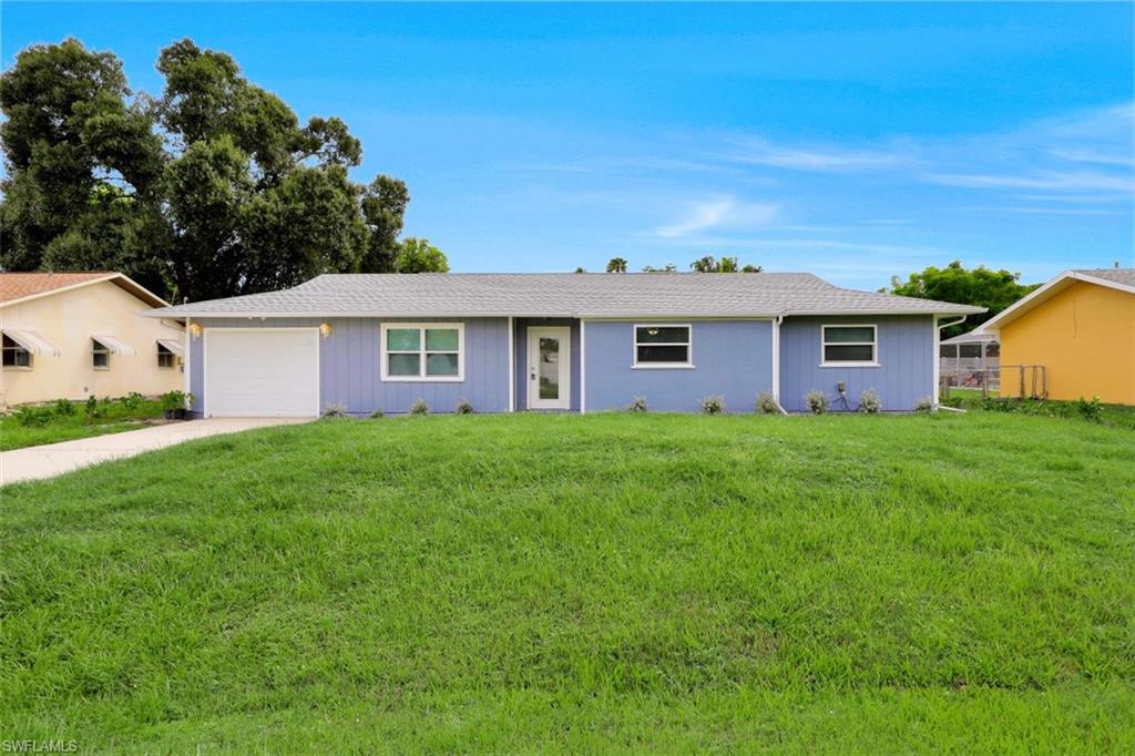 19109 Birch Road Fort Myers, FL 33967 - Photo 20 of 24 a front view of a house with a garden