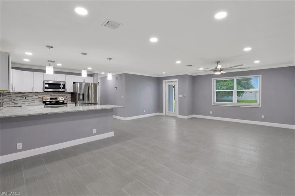 19109 Birch Road Fort Myers, FL 33967 - Photo 2 of 24 an empty room with wooden floor and windows
