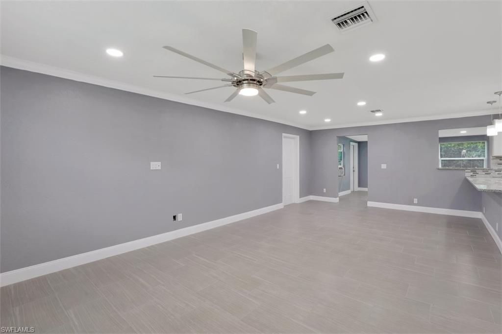 19109 Birch Road Fort Myers, FL 33967 - Photo 6 of 24 an empty room with windows and fan