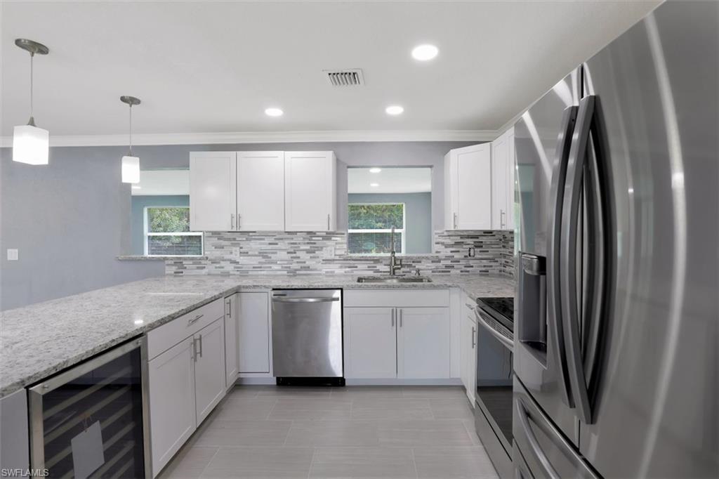 19109 Birch Road Fort Myers, FL 33967 - Photo 8 of 24 a kitchen with a sink stove and refrigerator