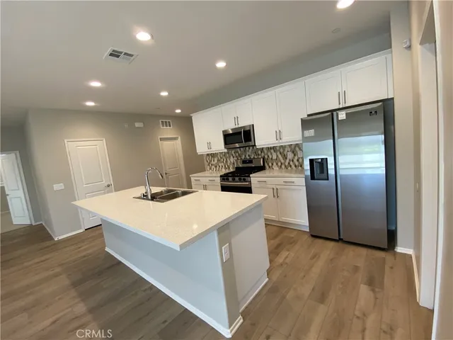 a kitchen with stainless steel appliances a microwave sink and cabinets