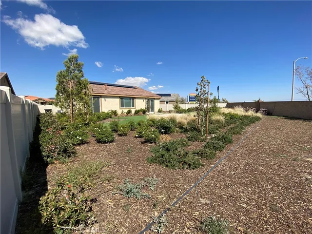 a view of a house with a yard and garden