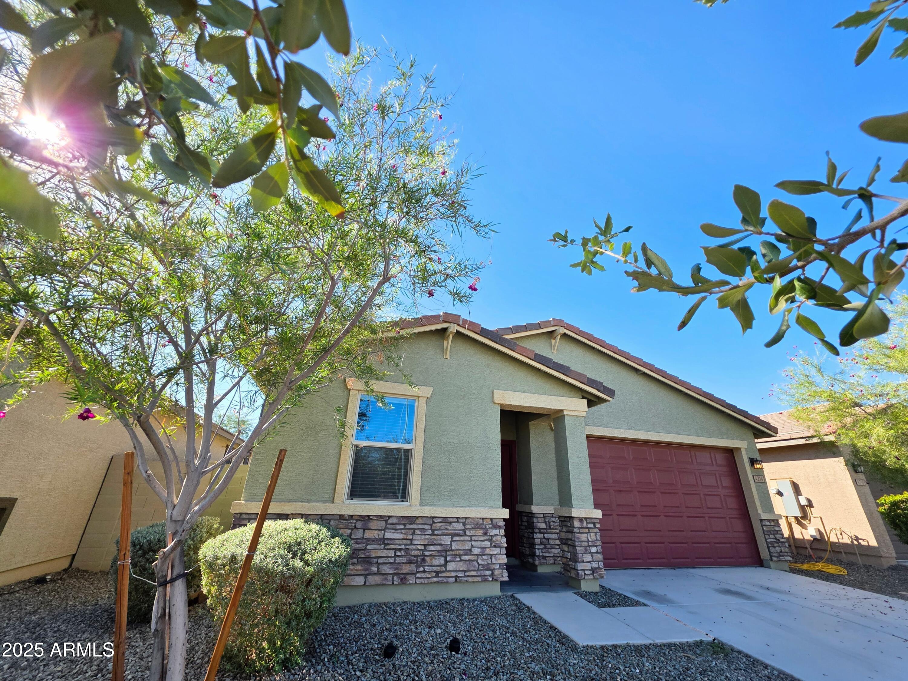4214 North 68th Lane Phoenix, AZ 85043 - Photo 2 of 13 a front view of a house with a yard