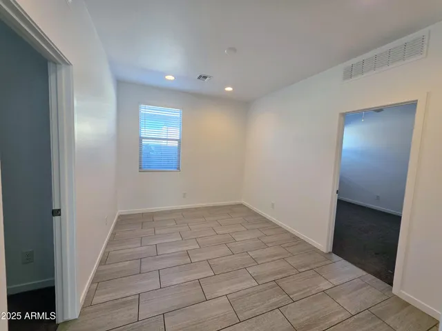 an empty room with white walls and tiles