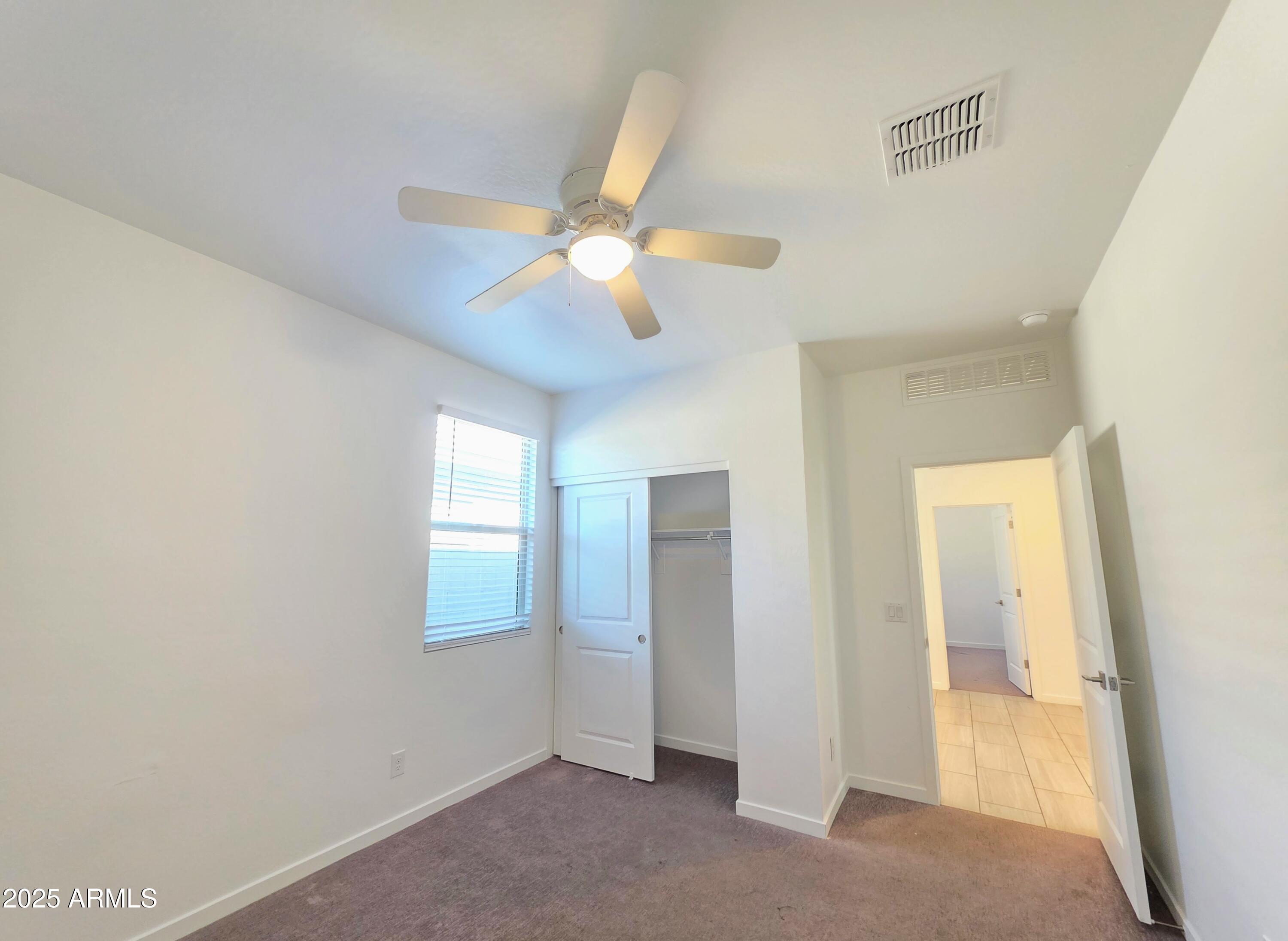 4214 North 68th Lane Phoenix, AZ 85043 - Photo 8 of 13 a view of empty room with window