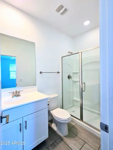 a bathroom with a toilet a sink and shower