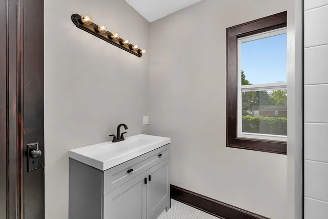 a bathroom with a sink and a mirror