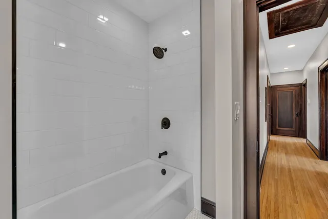 a bathroom with a bathtub and a shower