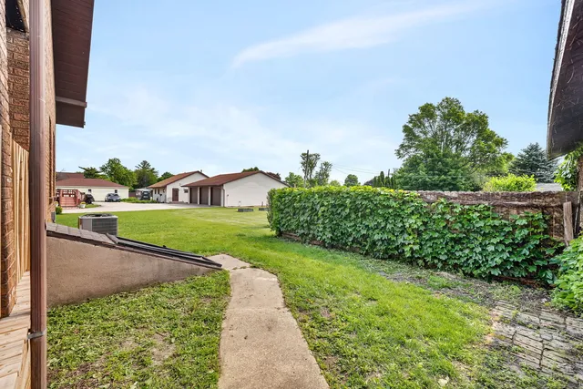 a view of a garden with a building in the background