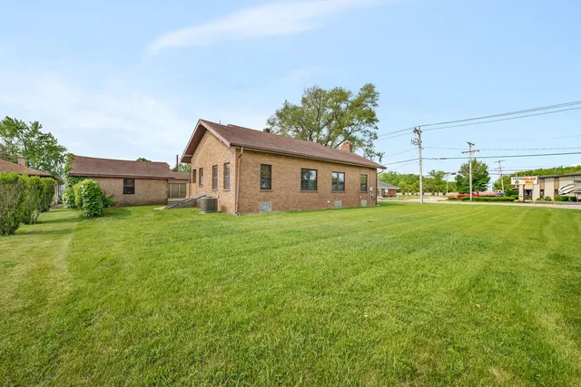a front view of house with yard and trees