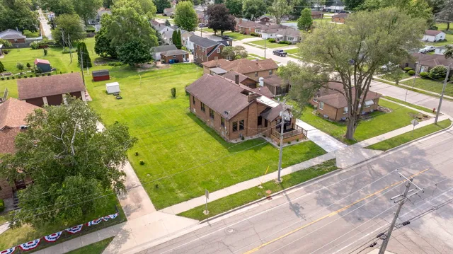 an aerial view of a house with a garden and swimming pool