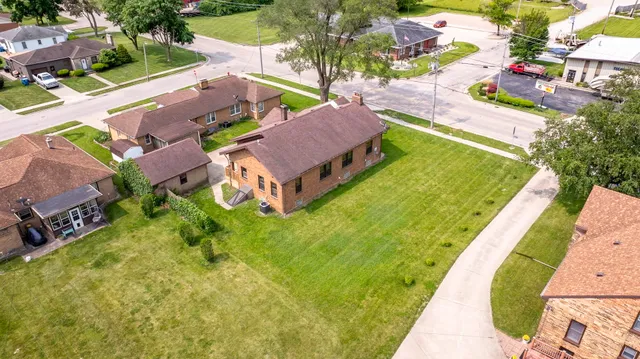 an aerial view of a house with a garden and swimming pool