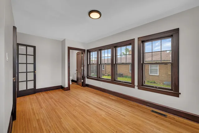 wooden floor in an empty room with a window