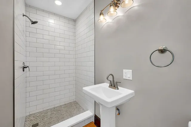 a bathroom with a sink a mirror and shower