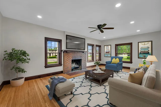 a living room with furniture fireplace and window