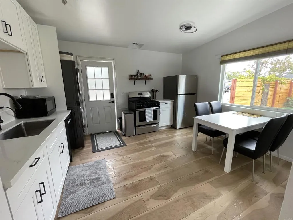 1153 Aloha Drive Encinitas, CA 92024 - Photo 12 of 50 a living room with furniture a fireplace and a flat screen tv