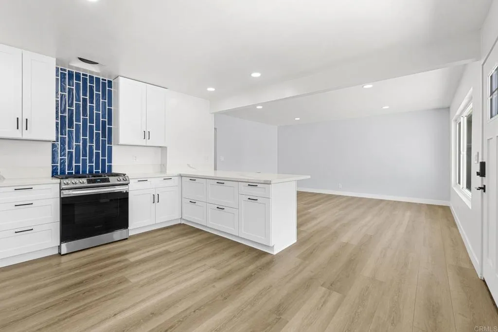 1153 Aloha Drive Encinitas, CA 92024 - Photo 26 of 50 a kitchen with wooden floors and white appliances