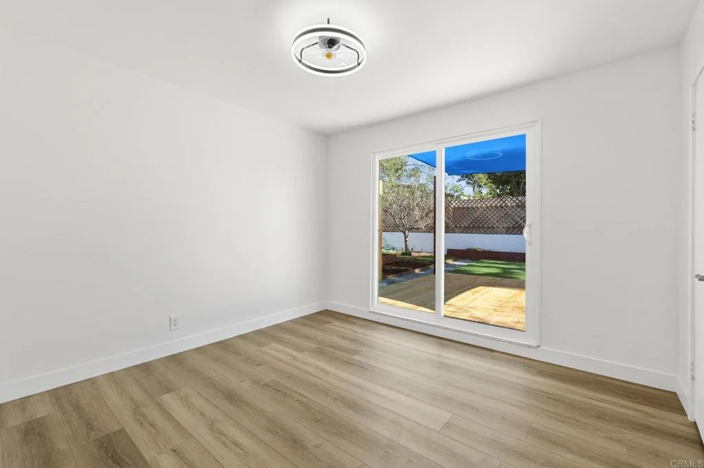1153 Aloha Drive Encinitas, CA 92024 - Photo 33 of 50 an empty room with wooden floor and windows