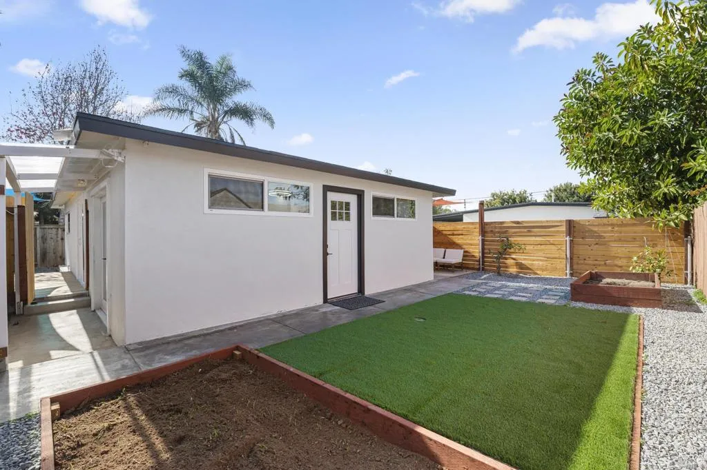 1153 Aloha Drive Encinitas, CA 92024 - Photo 39 of 50 a backyard of a house with table and chairs