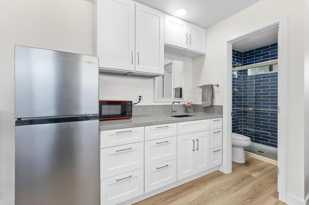 1153 Aloha Drive Encinitas, CA 92024 - Photo 46 of 50 a kitchen with stainless steel appliances a refrigerator and a sink