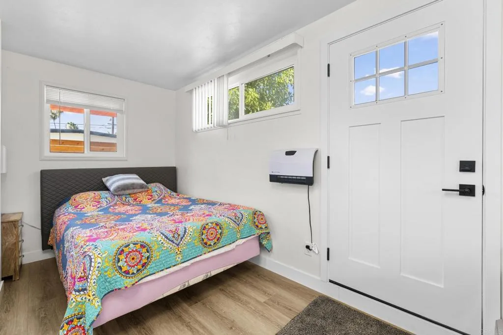 1153 Aloha Drive Encinitas, CA 92024 - Photo 47 of 50 a bedroom with a bed and a painting on the wall