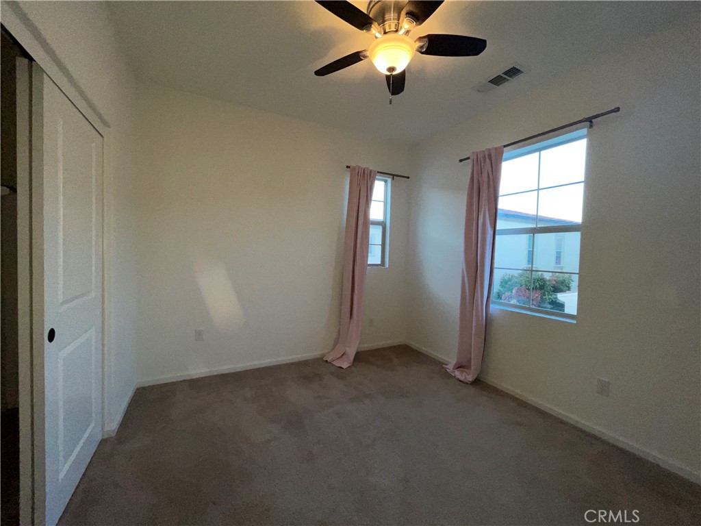 22083 Propello Drive Saugus, CA 91350 - Photo 19 of 21 an empty room with windows and fan