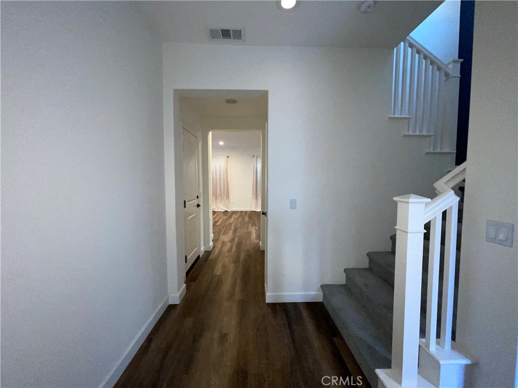 22083 Propello Drive Saugus, CA 91350 - Photo 3 of 21 a view of a hallway with wooden floor and staircase