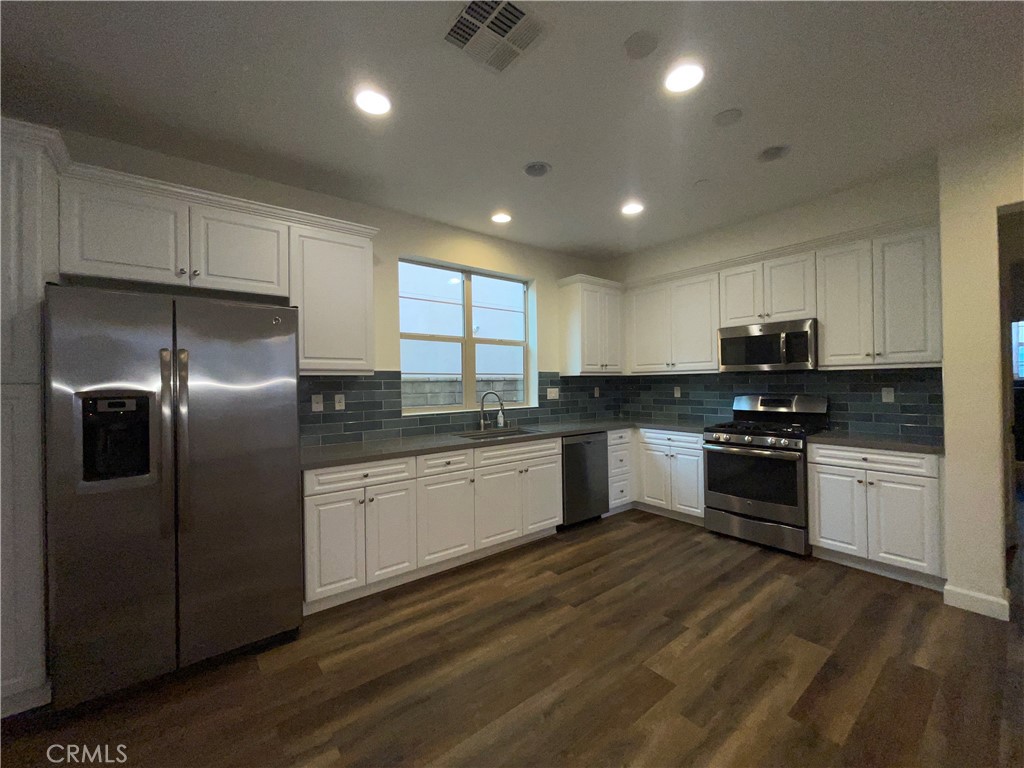 22083 Propello Drive Saugus, CA 91350 - Photo 5 of 21 a kitchen with granite countertop stainless steel appliances and white cabinets